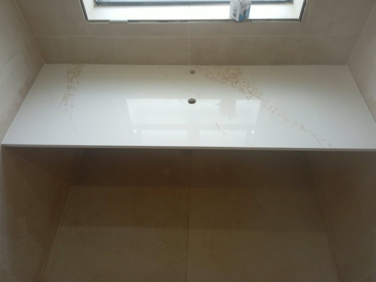 Finished white bathroom vanity surface with cut-outs